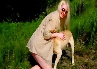 Blonde enjoys outdoor zoophilia by letting the dog lick her and smiff her ass