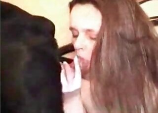 Brown-haired cocksucker is happy to sloppily suck on a dog's peen