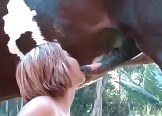 Whore bangs her cunt fast using a huge thick cock of a stallion